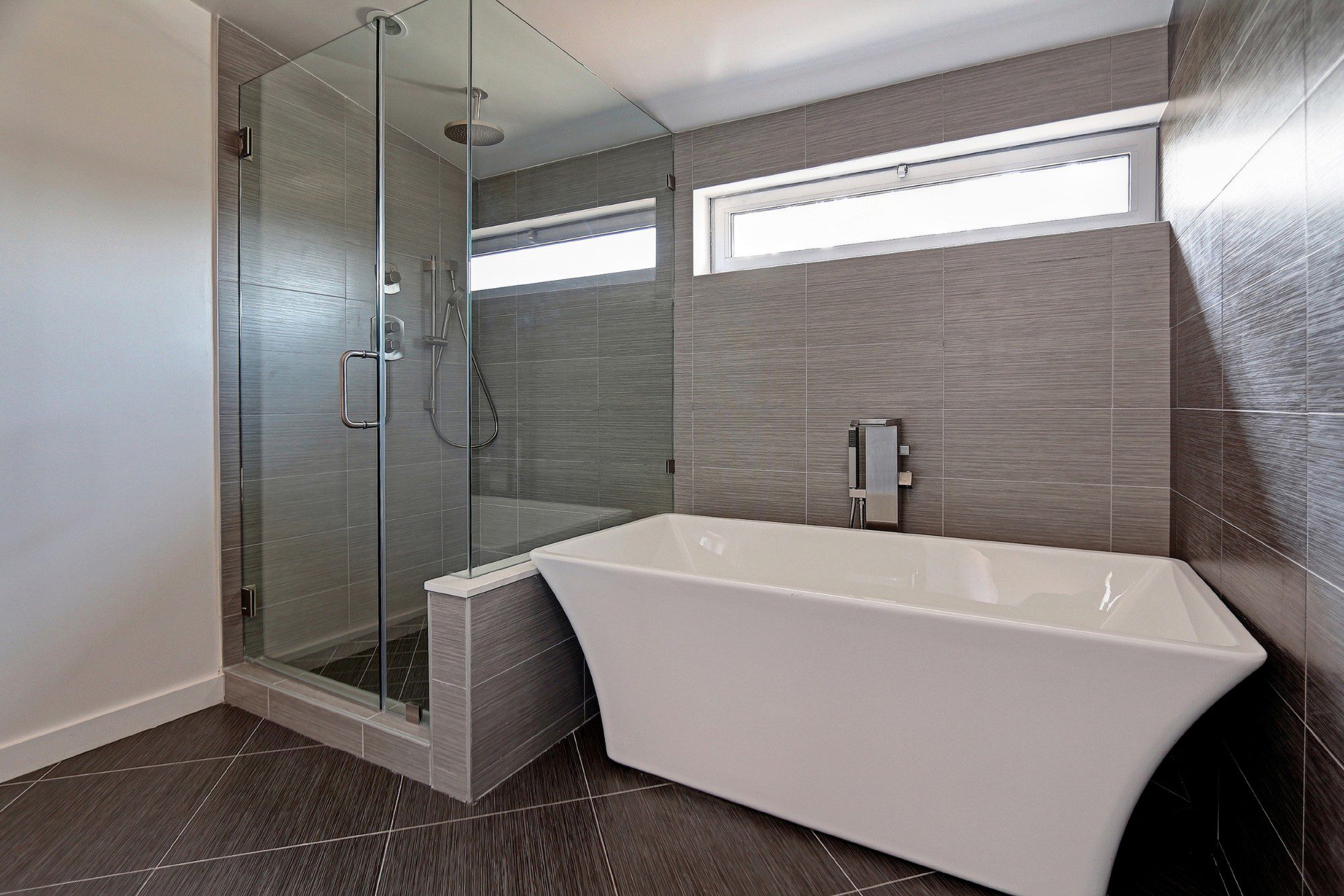 Stand alone tub and shower combo in custom minimalist bathroom