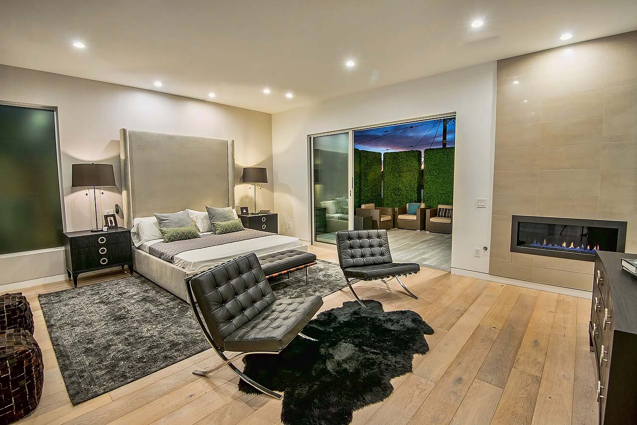 Spacious bedroom with balcony in Modern California home