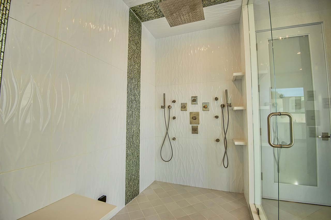 Spacious dual shower with bench in modern California home