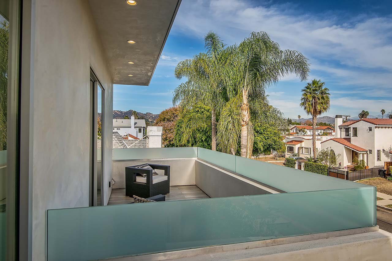 Bedroom adjoining balcony in modern California home