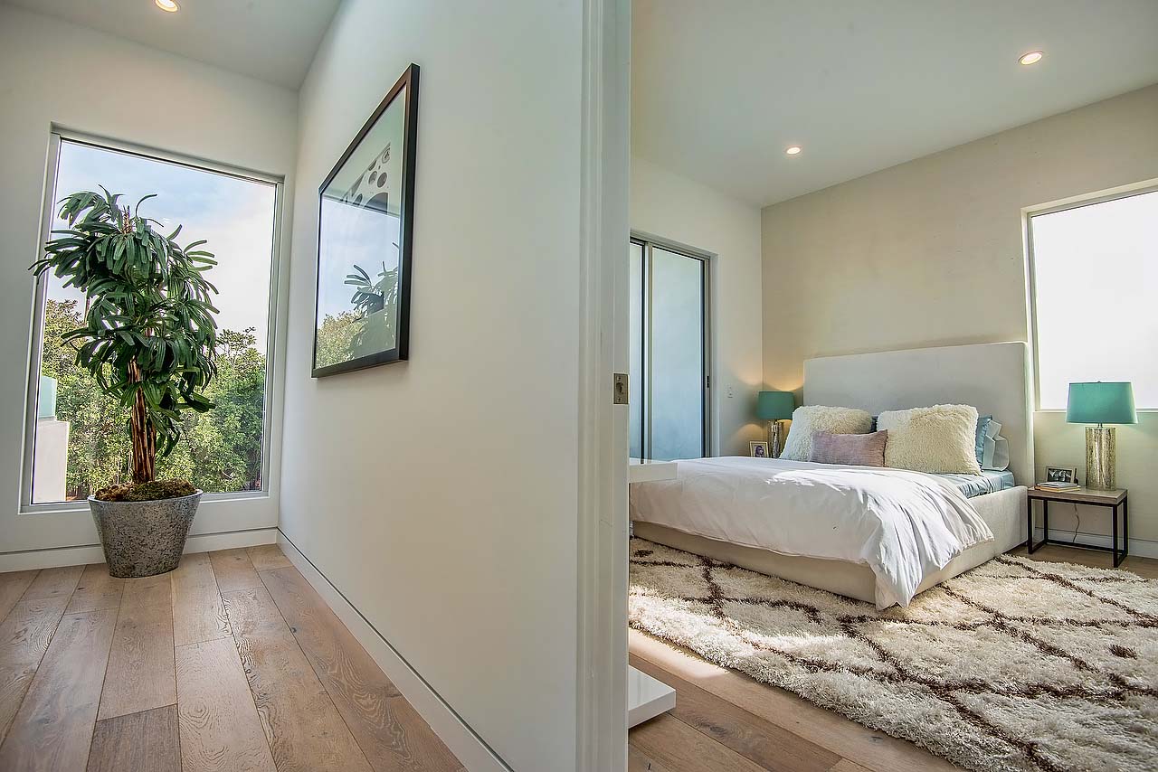 Stylish bedroom and hallway featured in California home